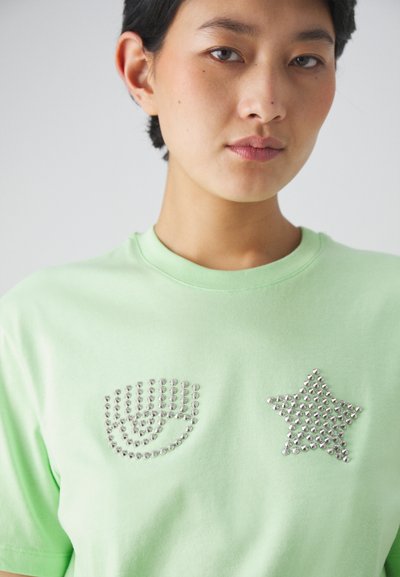Mint green cotton t-shirt featuring crystal embellishments in the shape of a hand and a star on the front. Classic crew neck design.