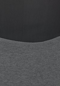 Gray fabric seamless blend, featuring a textured black top section with fine ribbing. Smooth gray bottom section with clean stitching.