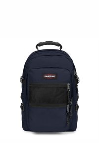 Námořnická modrá batoh Eastpak s polstrovaným zadním dílem, hlavním oddílem na zip, přední kapsou ze síťoviny a nastavitelnými popruhy. Obsahuje horní držadlo pro nošení.