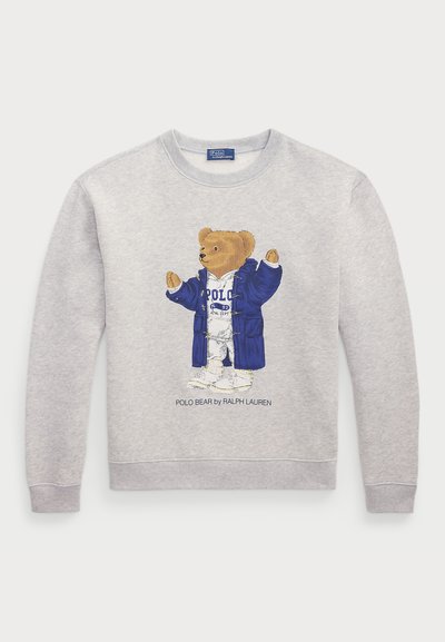 Helles graues Sweatshirt mit einem Grafikmotiv eines Bären in einem blauen Mantel und weißer Kleidung. Gerippte Bündchen und Saum. "Polo Bear by Ralph Lauren"-Text darunter.