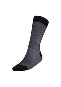 Calcetín a rayas negras y grises con la puntera y el puño en negro sólido. Presenta un logo impreso en el lateral, fabricado con un material suave y elástico.