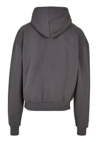 Grå hettegenser med en boxy passform, ribbestrikkede mansjetter og hem. Glatt tekstur, mid-lange ermer og minimalistisk design. Bakview vist.