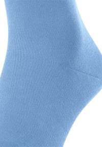 Απαλή μπλε βαμβακερή κάλτσα με λεία, υφασμένη επιφάνεια και σφιχτή εφαρμογή στον αστράγαλο, που διαθέτει ομοιόμορφο πλέγμα σε όλη την επιφάνειά της.