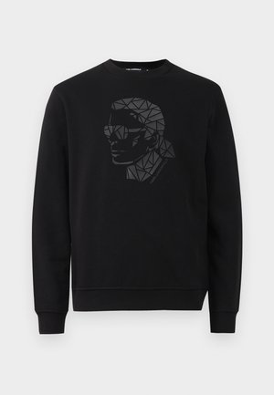Sorte sweatshirt med rund halsudskæring og lange ærmer. Har et geometrisk portræt-design i sort og grå på forsiden.
