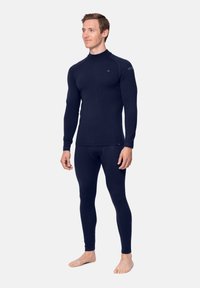 Marineblaues Thermo-Basisschicht-Set mit langärmeligem Oberteil und enganliegenden Leggings, gefertigt aus strukturiertem, elastischem Stoff für Komfort und Wärme.