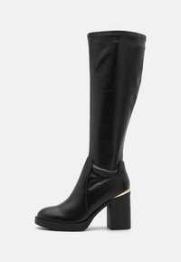 Black knee-high boot with a smooth synthetic material, round toe, chunky high heel, and a gold accent on the heel. Seamless design.