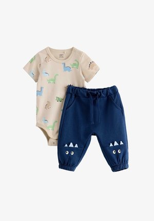 Body beige per neonati con stampe colorate di dinosauri e pantaloni blu navy con occhi e punte sulle ginocchia e polsini elasticizzati.