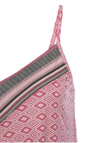 Pink patterned top featuring geometric designs, black and white striped accents, thin straps, and a textured fabric at the neckline.