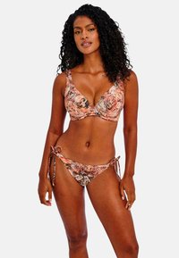 Bra and bikini set featuring a colorful, abstract print in shades of orange, brown, and black. Material has smooth texture. Adjustable ties on bikini.