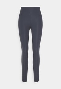 Leggings de cintura alta en tejido gris oscuro, con una textura suave, forma estilizada y paneles laterales que añaden un toque moderno.