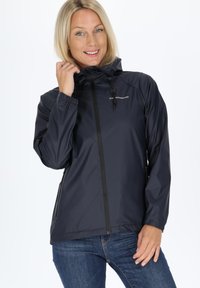 Navy windbreaker jacket with a hood, zip closure, elastic cuffs, and side pockets. Smooth, water-resistant material. Logo on the front.