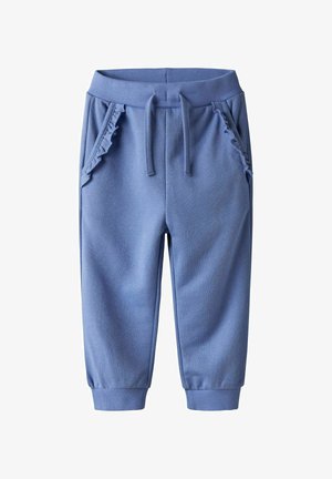 Blå bomulls joggebukser med ribbestrikket midjebånd, snøring, sidelommer med volanger og elastiske mansjetter ved ankelen.