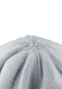 Light gray knitted beanie with a rounded crown, featuring a central knot. The fabric has a soft, textured appearance with visible stitches.