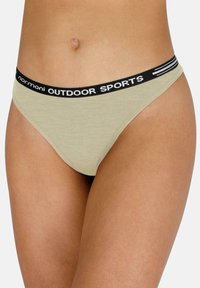Beige Baumwoll-Tanga mit schwarzem Gummibund, auf dem "normani OUTDOOR SPORTS" steht. Weiche Textur, minimales Deckungsdesign, keine zusätzlichen Akzente.