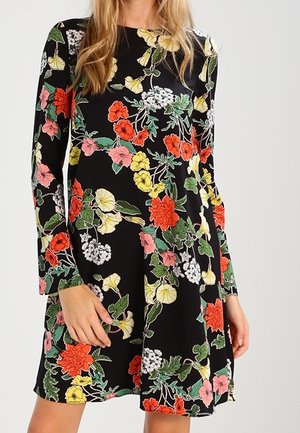 Robe noire à manches longues avec un motif floral comprenant des fleurs rouges, roses, jaunes et blanches, de forme évasée et au toucher doux.