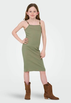 Green ribbed dress with thin straps and wooden accents, paired with brown ankle cowboy boots, featuring a fitted design and mid-length cut.