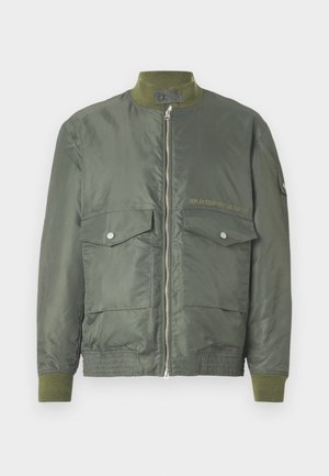 Olivovo zelená bomber bunda so zipsom, rebrovanými manžetami a golierom. Dve predné vrecká so zapínaním na cvoky. Obsahuje embosované logo.