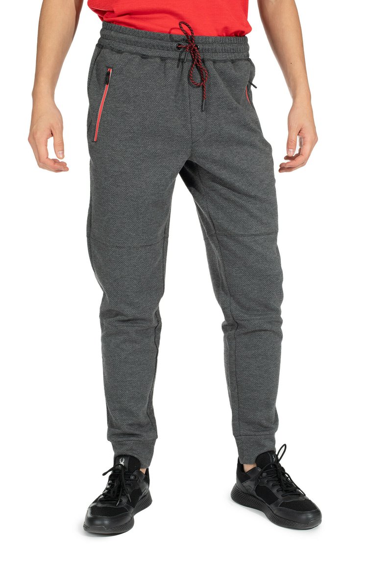 Graue Jogginghosen aus strukturiertem Stoff, mit schwarzen und roten Reißverschlusstaschen sowie einem elastischen Bund mit Kordelzug.