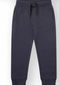 Pantalones deportivos azul marino hechos de tela suave, con cintura elástica y cordón, y dos bolsillos laterales. Puños en los tobillos.