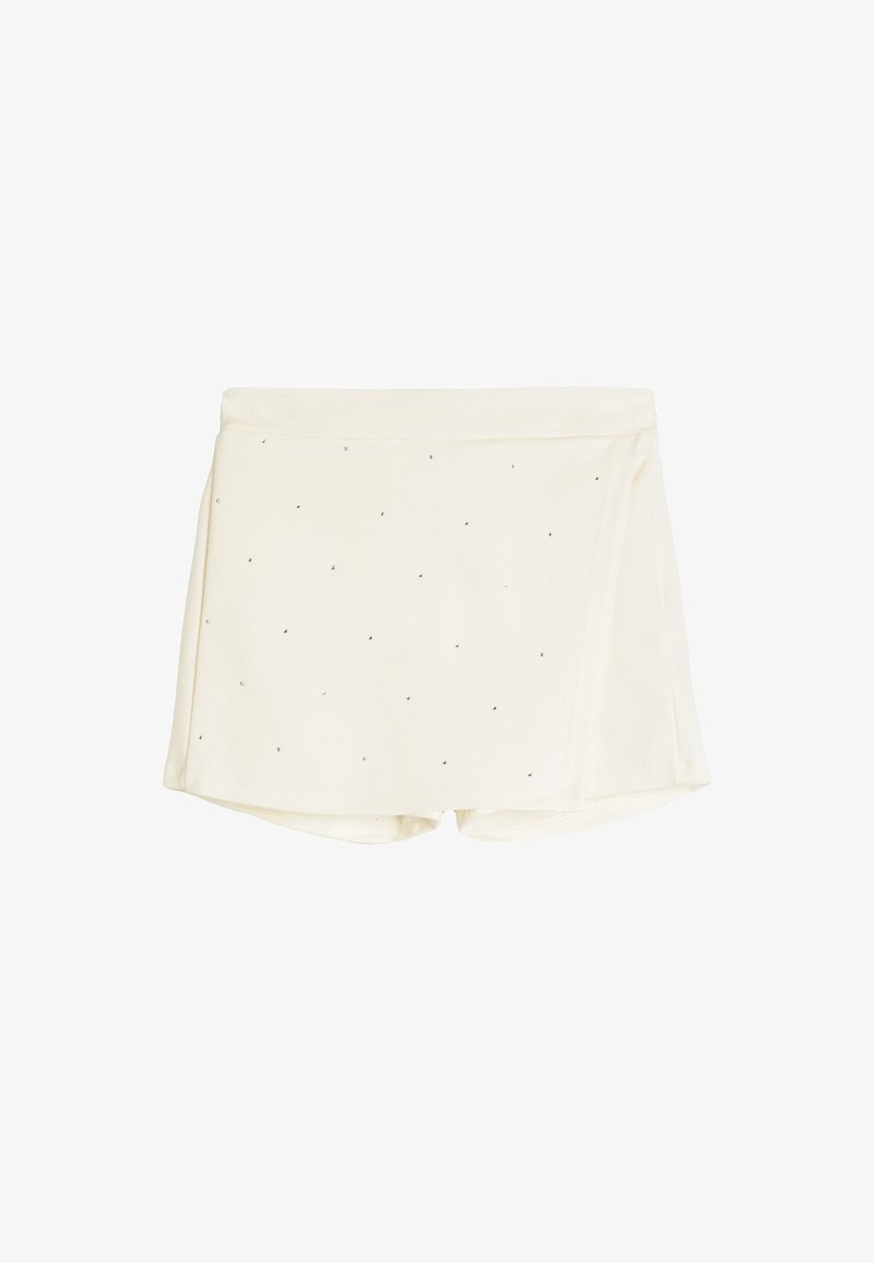 Pantaloni corti color crema in un tessuto liscio e strutturato, con piccoli punti neri sparsi sulla superficie e un design avvolgente.