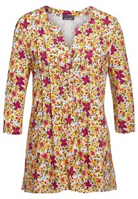 Blumen-Tunika mit V-Ausschnitt und drei Viertelärmeln; überwiegend gelber Stoff mit rotem, grünem und blauem Blumenmuster sowie Faltendetails.