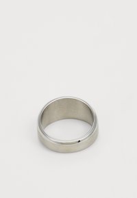 Metal ring with a smooth, polished surface and matte finish. Its rounded shape features a small notch on the side. Silver color.