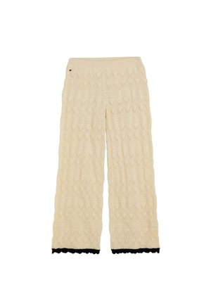 Pantalones anchos de punto color crema con patrón de zigzag y borde negro con ondas en el dobladillo, con un pequeño detalle redondo cerca de la cintura.