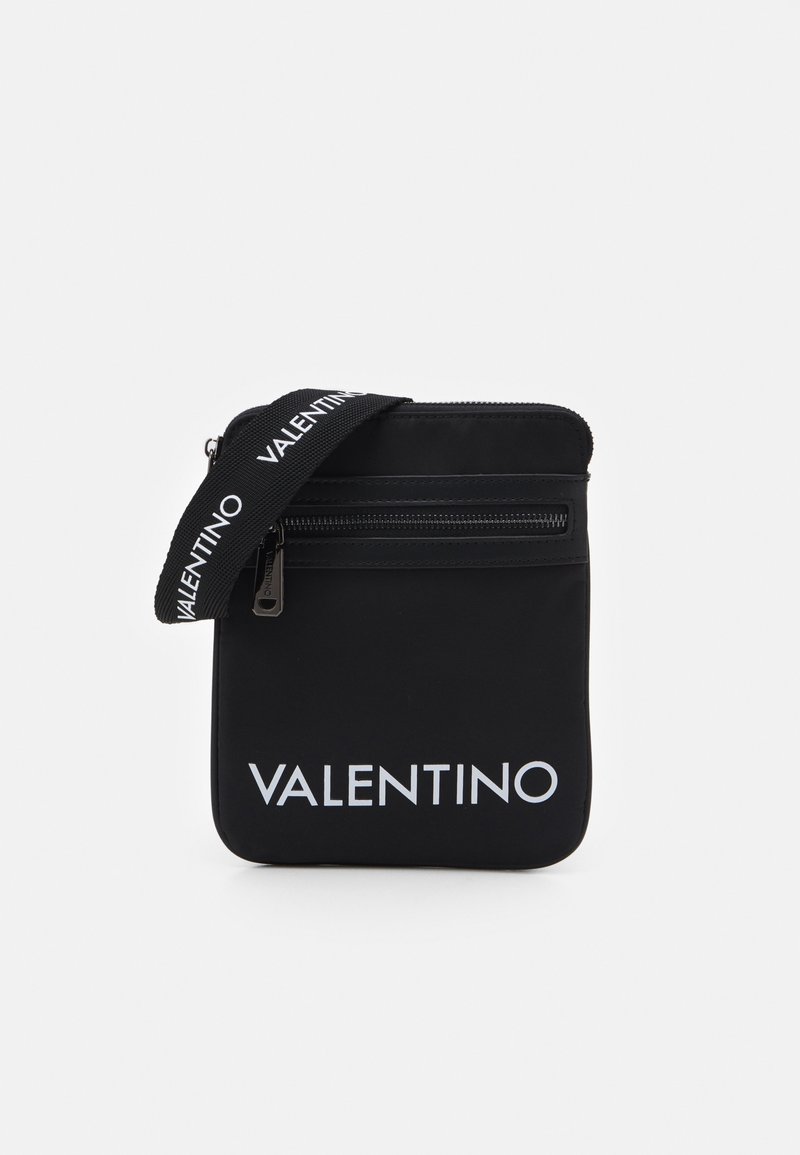 Black nylon crossbody bag with zip closure, featuring a prominent white "VALENTINO" logo and a textured adjustable strap.