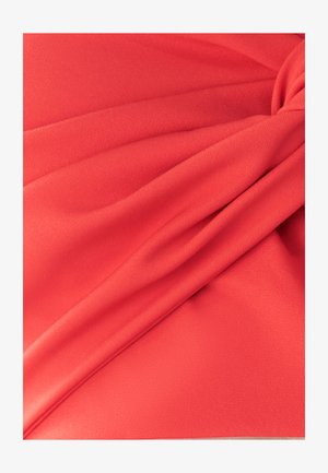 Red fabric with soft texture, featuring draped folds and a knotted accent. Material appears lightweight and smooth.