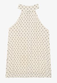 Sleeveless halter top in cream with brown polka dots, featuring a high neckline and pleated fabric for added texture.