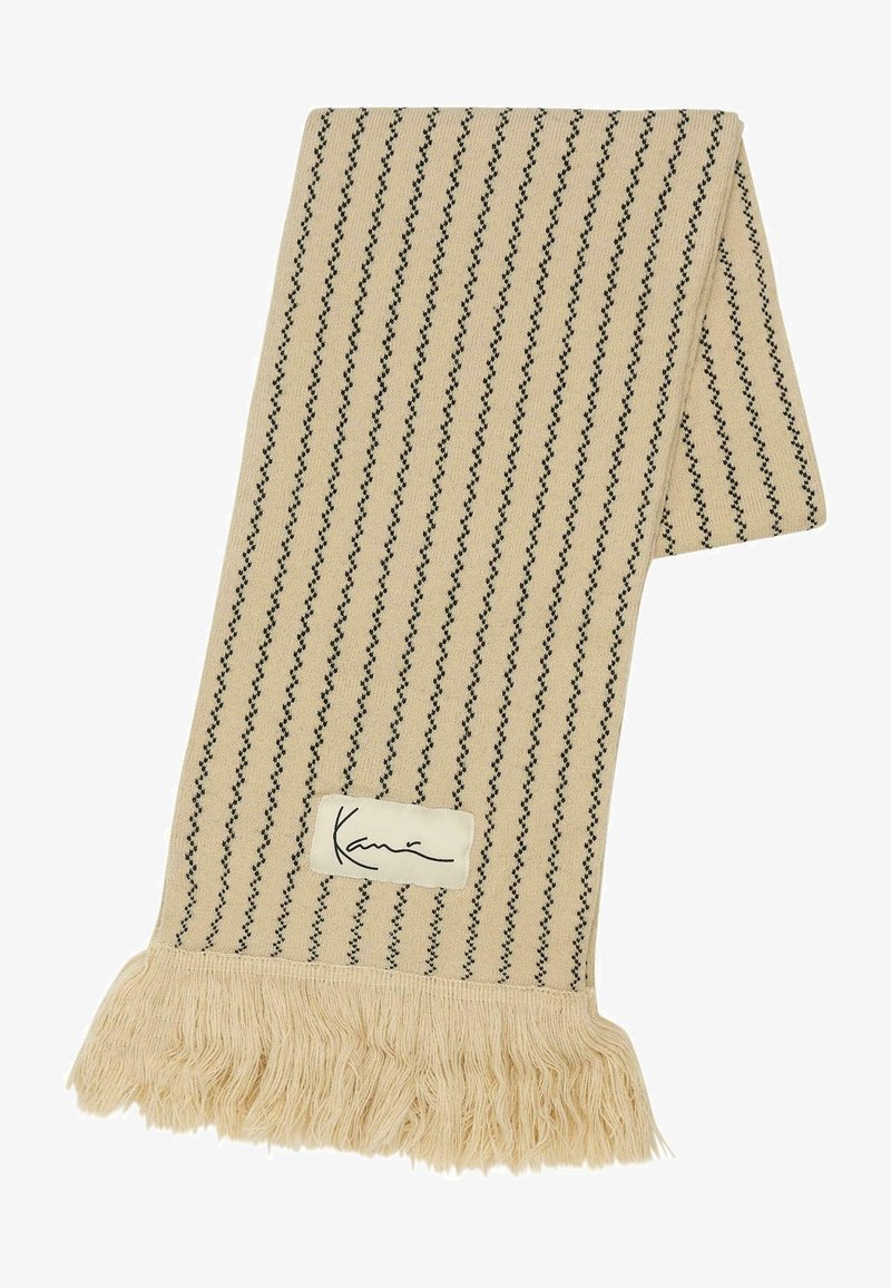 Sciarpa intrecciata beige con strisce verticali nere, con dettagli frangi su un'estremità e un'etichetta cucita con la firma "Kavi".
