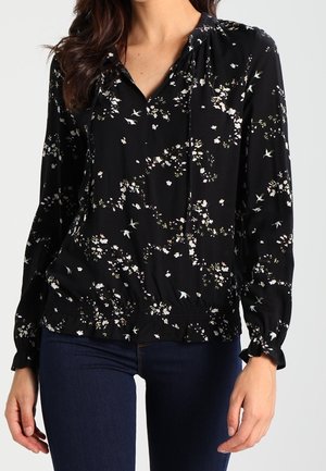 Blusa nera con motivo floreale, con scollatura arricciata, maniche lunghe e vita elasticizzata. Tessuto leggero con una texture liscia.