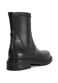 Black leather ankle boot with a smooth texture, rounded toe, reinforced back, and a durable rubber sole featuring a tread pattern.