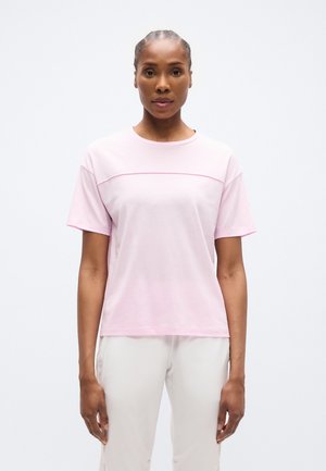 Light pink short-sleeve t-shirt featuring a crew neck, horizontal seam detail across the chest, and a relaxed fit. Soft fabric texture.