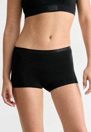 Black cotton boxer shorts with a smooth waistband, featuring a simple design and minimal stitching details. Suitable for everyday wear.