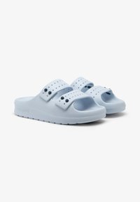 Light blue rubber slide sandals with two wide straps featuring ventilation holes and black button accents. Textured sole for grip.