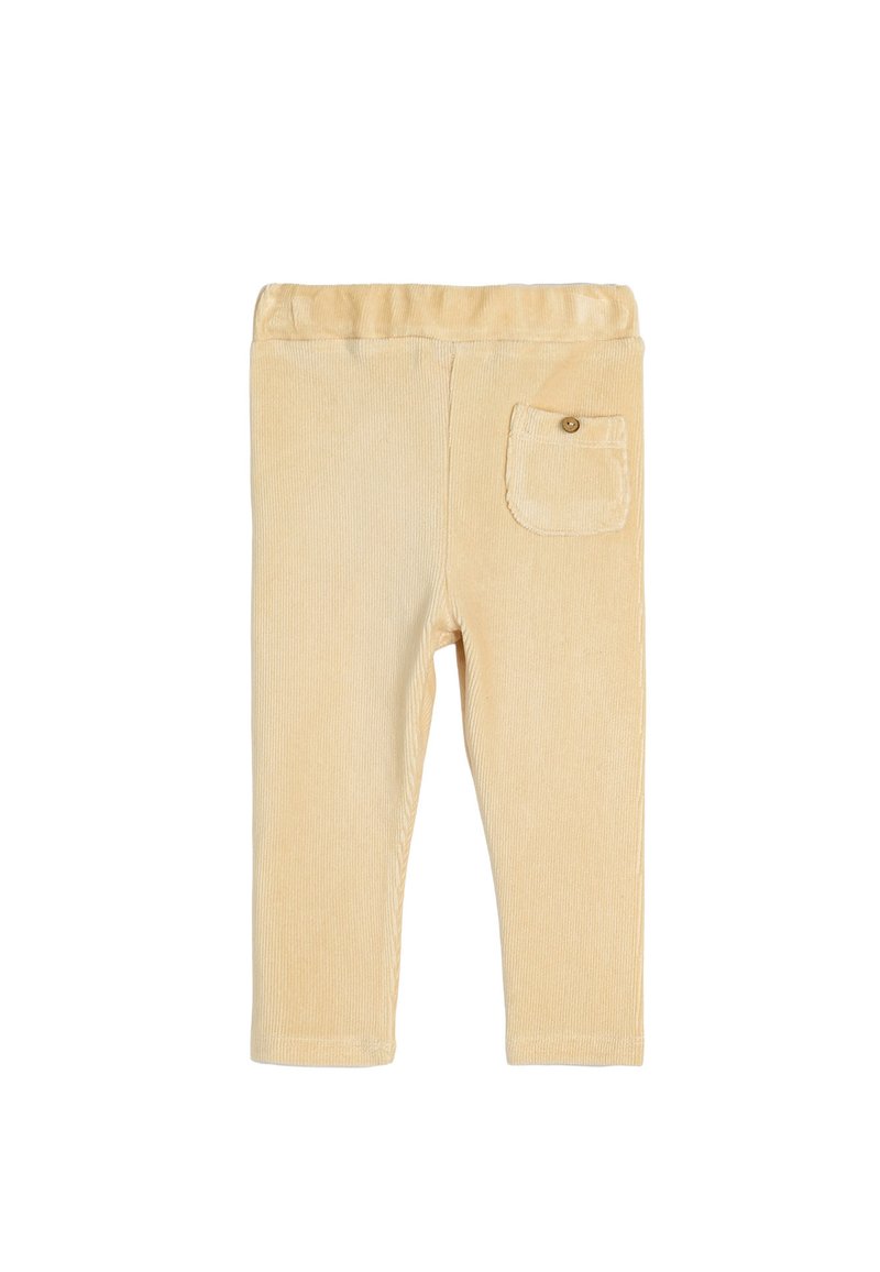 Lys beige fløjlbukser med en blød tekstur, elastisk talje og en enkelt påsyet lomme bagpå med en knap.