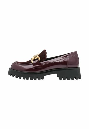 Burgundy patent leather loafer with a textured burgundy vamp, gold hardware detail, and a chunky black rubber sole with a jagged edge.