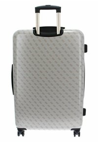 Valise rigide avec une surface blanche à motifs, ornée de logos discrets, accents noirs, poignée télescopique et quatre roues pour la mobilité.