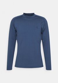 Marinblus med lång ärm och mock neck, tillverkad av ett mjukt och elastiskt tyg med en diskret logotyp på bröstet och flata sömmar för ökad komfort.