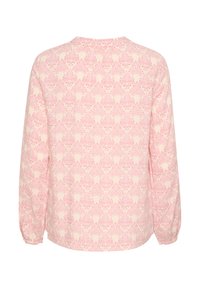 Langærmet top i lys pink med et cremet blomstermønster, der har rund halsudskæring og samlede manchetter for en afslappet pasform.