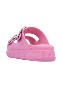 Pink rubber sandal featuring a wide strap with silver hardware, open back, and textured sole for improved grip. Curved design enhances comfort.