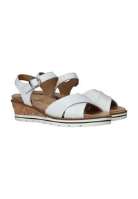 Sandalias blancas de cuña con tiras cruzadas, detalle de hebilla, textura similar a corcho en la suela y un leve tacón elevado. Parte superior de cuero suave.