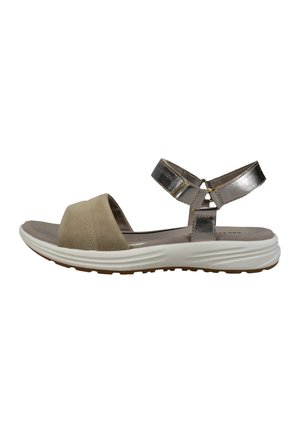 Sandalia de ante beige con tiras metálicas plateadas y una suela blanca contorneada. Presenta puntera abierta y tiras ajustables en el tobillo para un ajuste óptimo.