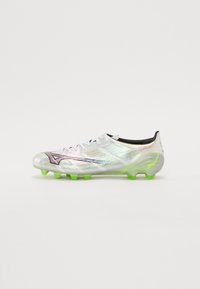 Witte voetbalschoenen met iriserend materiaal, groene noppen en zwarte accenten. Beschikt over een gestroomlijnd ontwerp en een traditioneel vetersysteem.