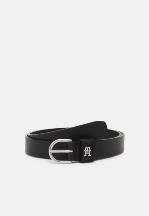 Black leather belt with silver rounded buckle and small silver logo on the belt loop, laid flat on a white background.