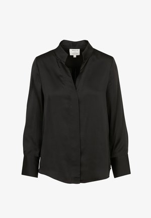 Black silk blouse with a collar, long sleeves, and a concealed front placket. Smooth texture and straight hem with side slits.