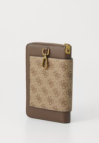 Brown and beige patterned wallet with gold-tone clasp and zipper pull engraved with brand name on white background.