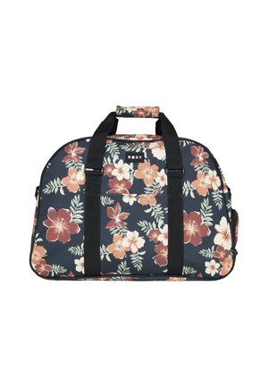 Sac de sport floral avec un fond bleu marine, de grandes fleurs d'hibiscus dans des tons de rose et d'orange, des poignées noires et un patch de marque.