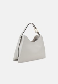 Sac à main en cuir gris avec une forme structurée, des finitions noires contrastantes et un détail en métal doré sur la poignée.
